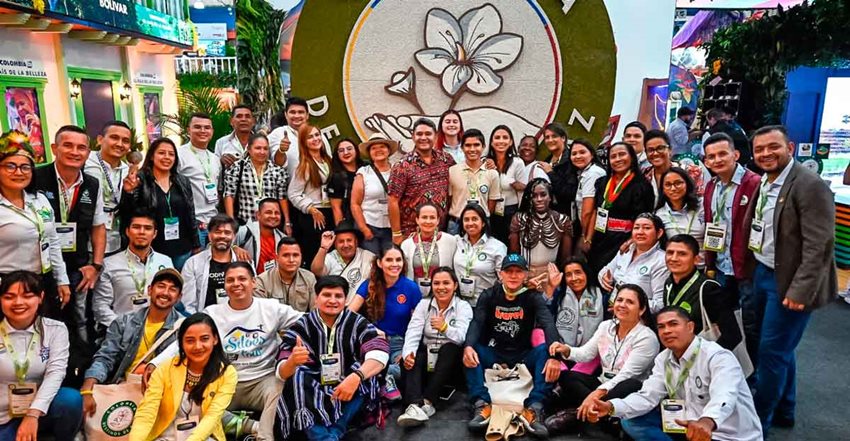 Personas posando para la foto delante del Sello Turismo de Paz.
