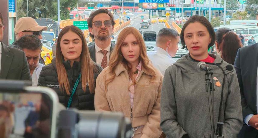 Tres mujeres frente a una cámara, listas para dar declaraciones, y detrás varias personas transitando.
