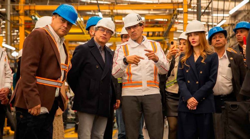 Presidente Petro y ministra Morales hablando con hombres en medio de planta de producción, todos con seguridad