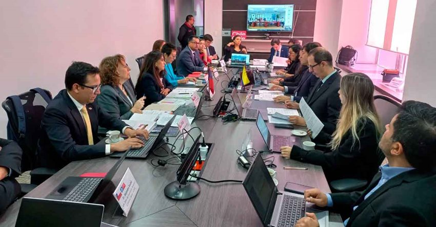 Personas reunidas alrededor de una mesa, dialogando en medio de una reunión.