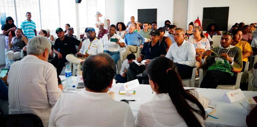 Personas reunidas en un salón dialogando.