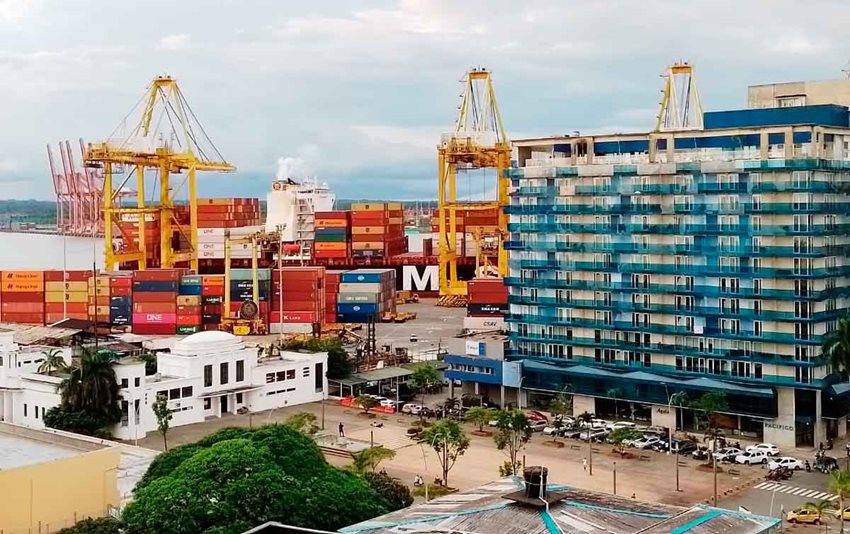 Edificios en Buenaventura y al fondo el puerto con contenedores de colores descargados.