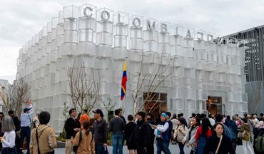 Personas caminando frente al pabellón de Colombia en Japón, que es blanco y con bandera del país a la entrada. - Colombia proyecta su liderazgo en Expo Osaka 2025 y abre nuevas oportunidades de diversificación comercial