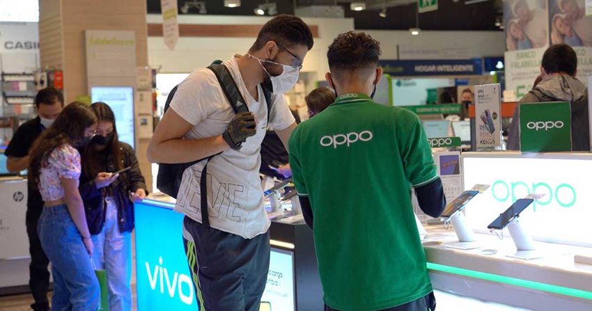 Personas en la sección de tecnología de almacén de cadena comprando productos en el primer día sin IVA 2022.