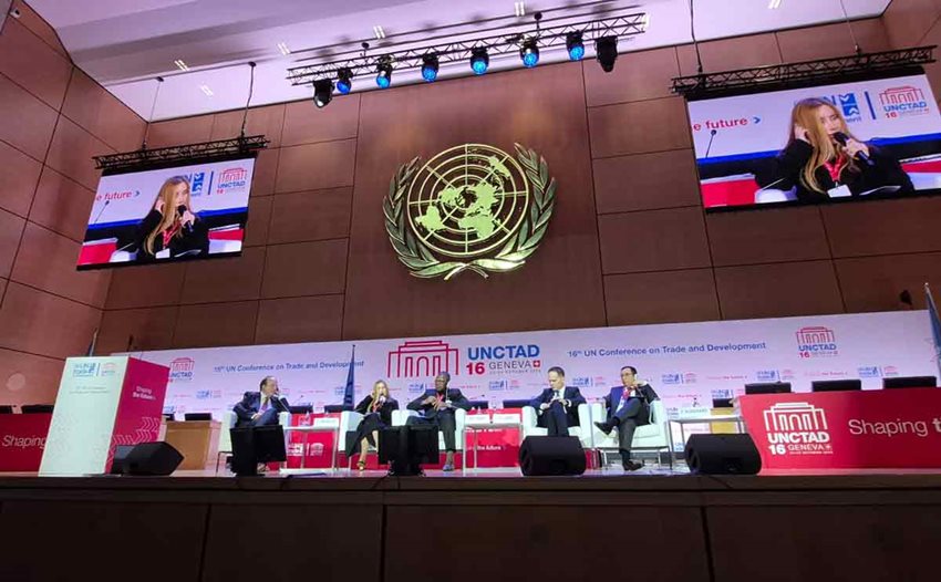 Ministra Morales, junto a cuatro hombres, exponiendo al público desde el escenario.