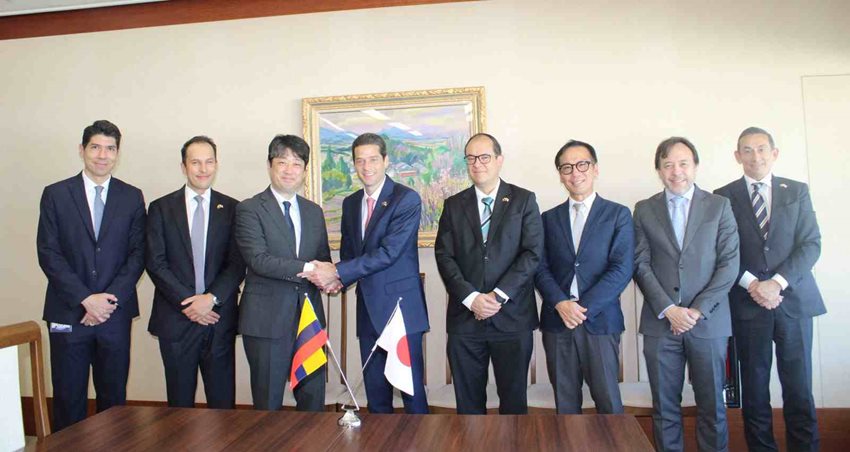 Ministro Mauricio Gómez Amín reunido con siete personas más y dándole la mano a una de ellos, mientras la foto
