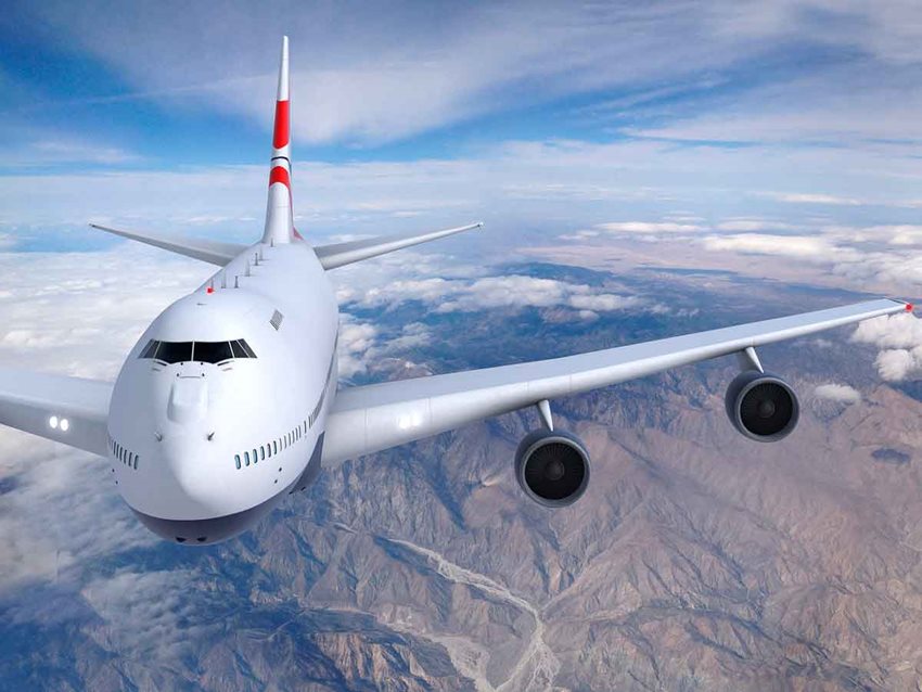 Avión blanco volando sobre montañas en el día.